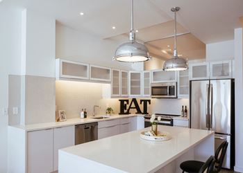 a kitchen with an eat sign on the wall at Sky on Main in Missouri